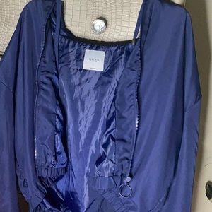 Dark Blue Windbreaker with bright orange stripes.